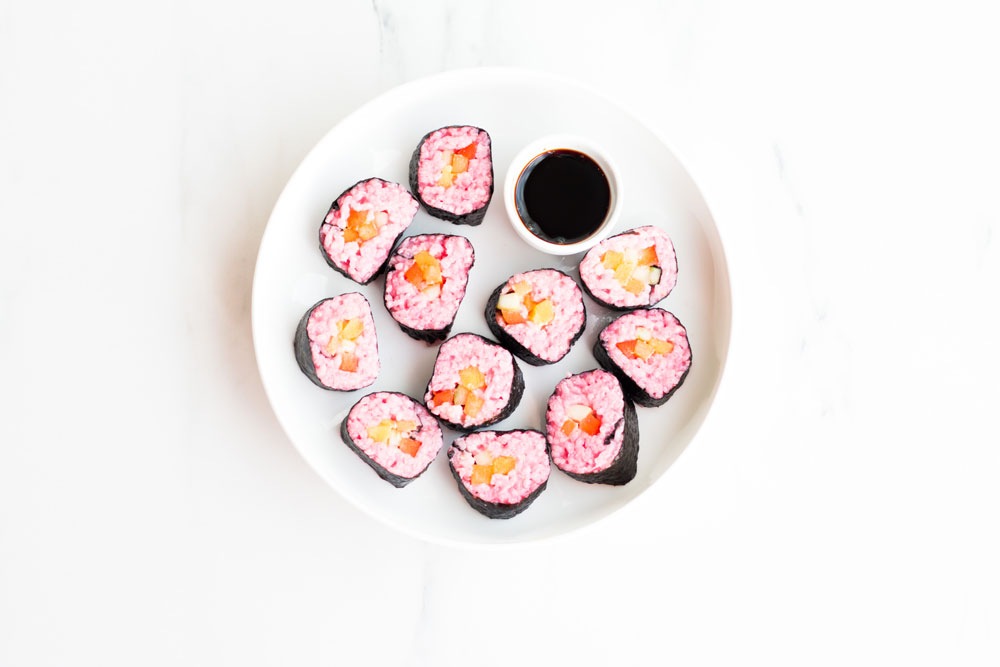 Simple, fresh and vegan Avocado & Mango Sushi recipe. These pink rice stacks are bite-sized, super tasty and the pink adds an adorable twist to your meal thanks to the secret ingredient, beet juice! https://www.spotebi.com/recipes/avocado-mango-vegan-pink-sushi/